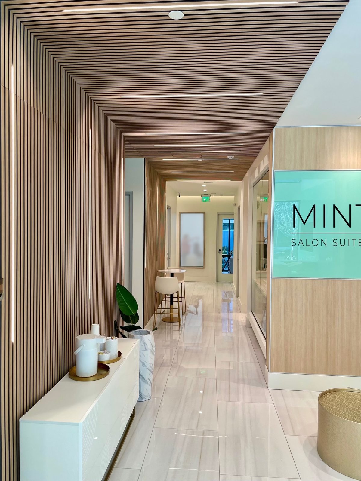 MINT entry corridor with wood slat walls and MINT sign